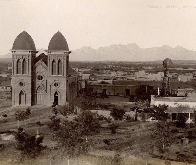 Historic St. Genevieve church with the Organ Mountains in the distance.